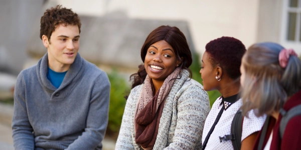 Four students talking outside