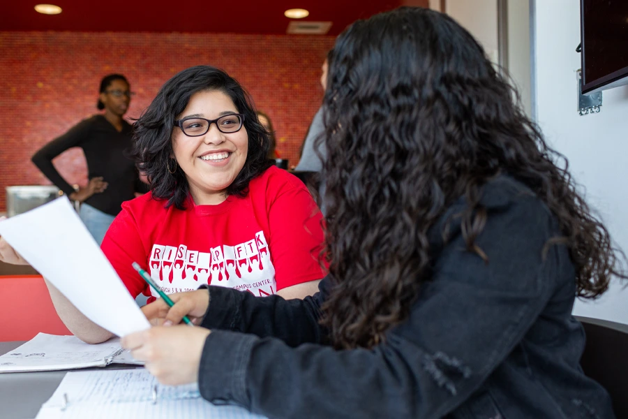 Two women review a worksheet