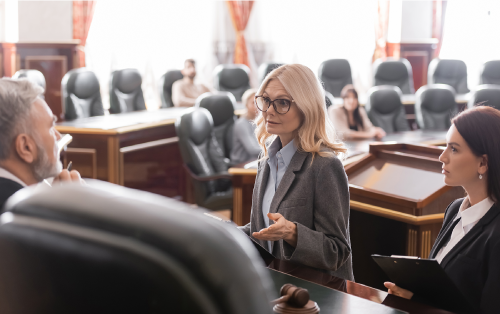 A woman speaking to a judge in a courtroom