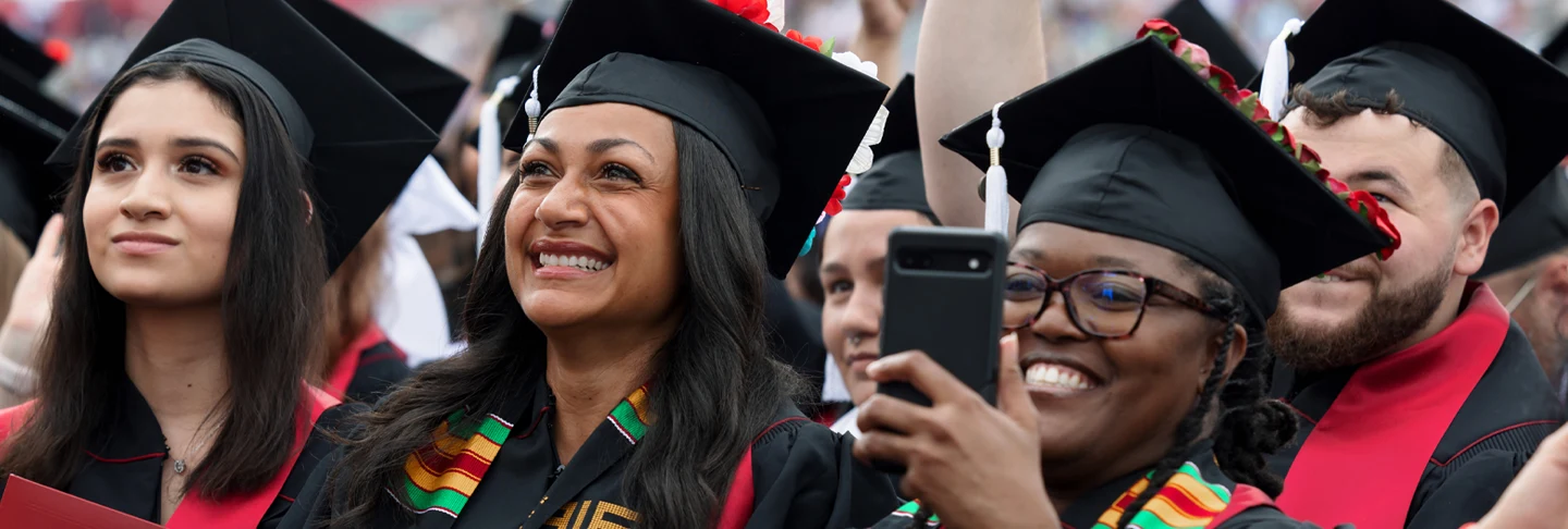 A group of students in caps and gowns celebrating their graduation