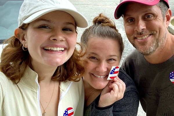 Image of Jennifer Rose posing with her daughter and husband